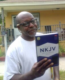 Man with a new Bible in College Hill, Tampa.
