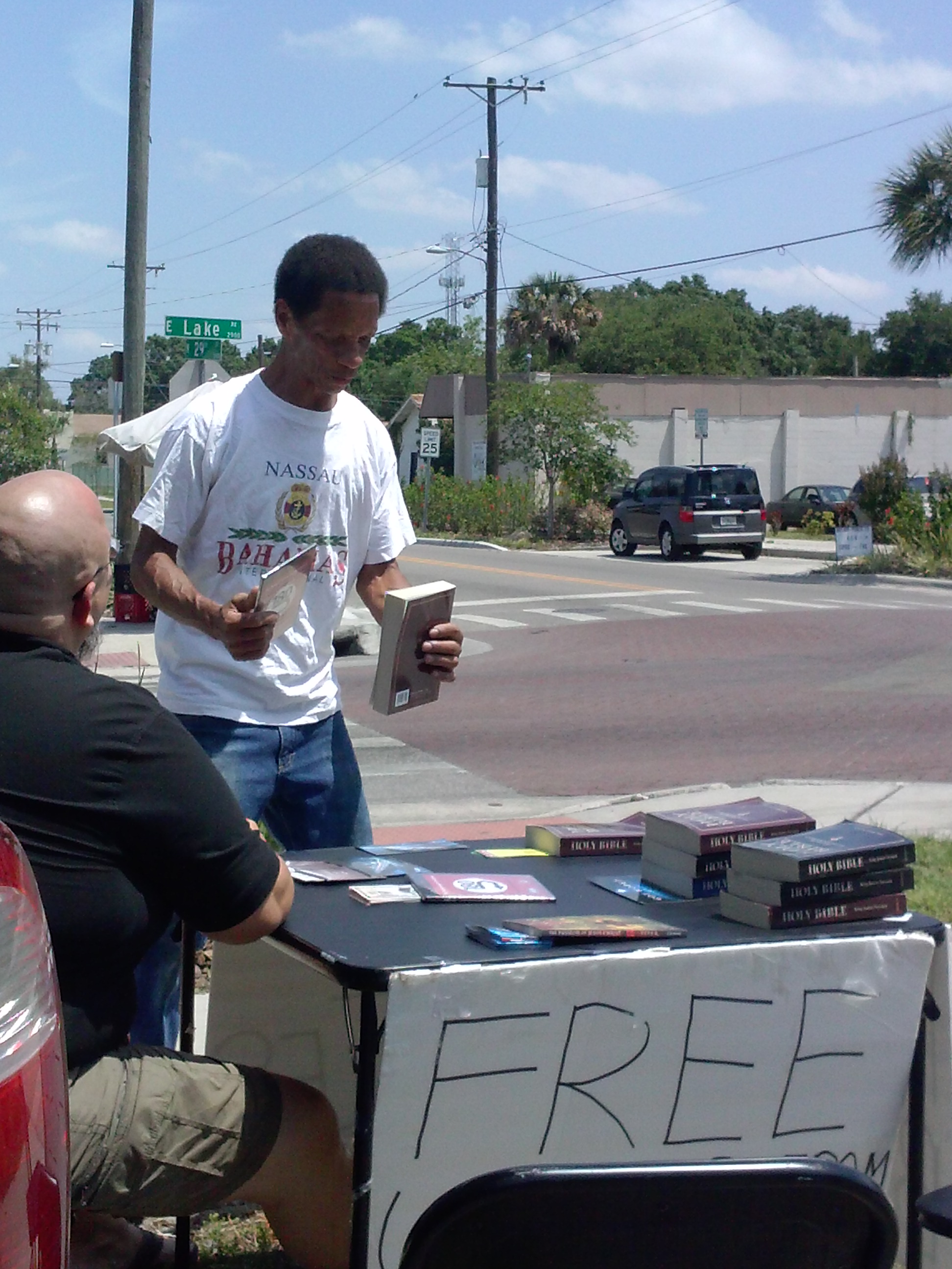 Man with Bible at College Hill table ministry