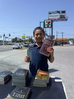 Young boy with Bible at Nebraska Ave. table