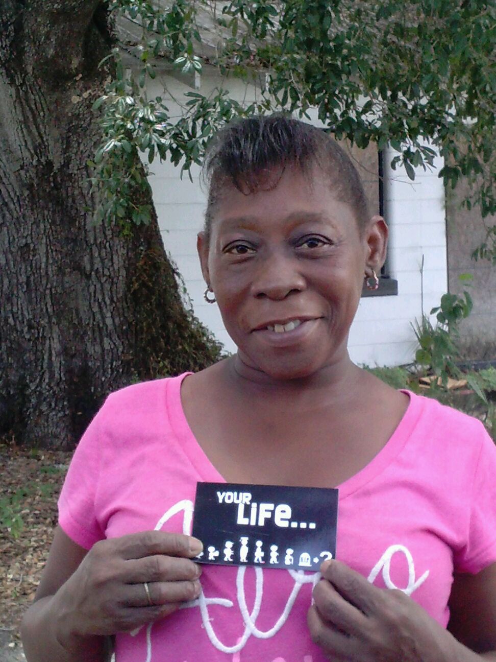 Gloria with a tract at the table ministry in College Hill