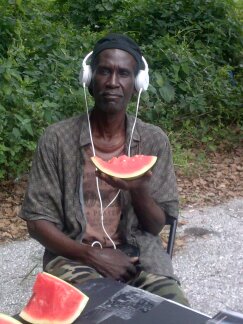 Homeless man eating watermelon